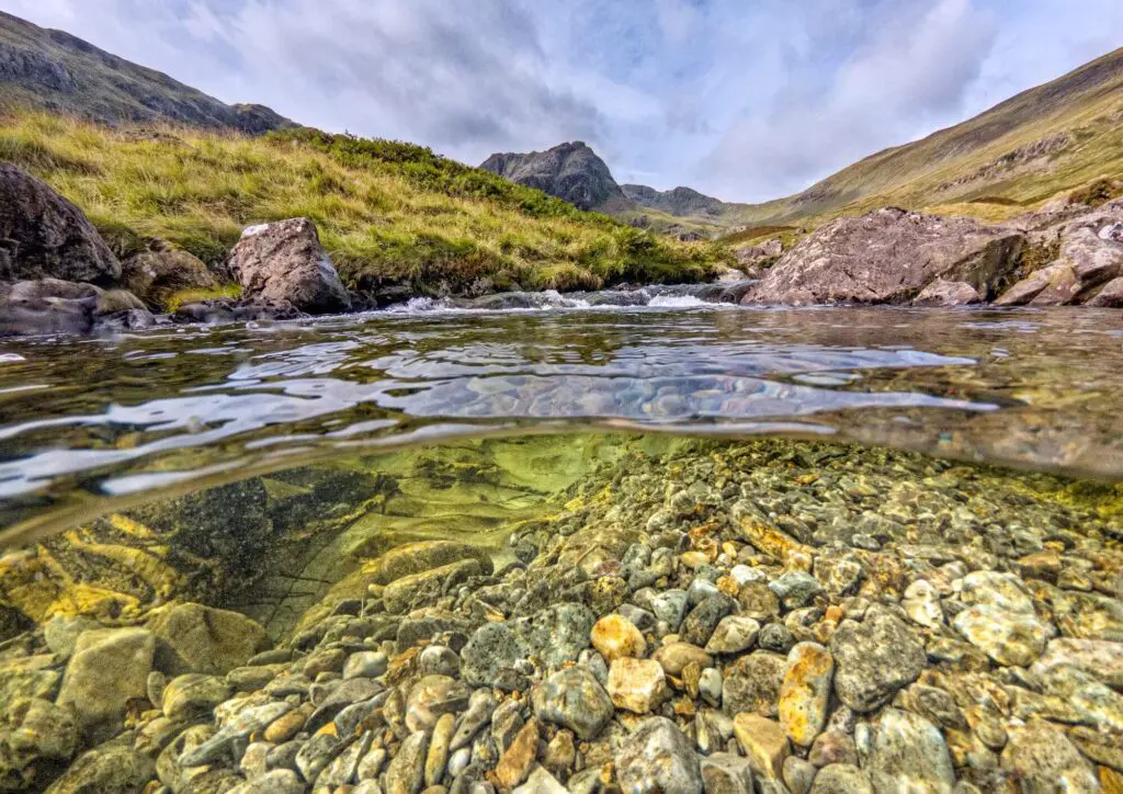 A clear pool and green hills