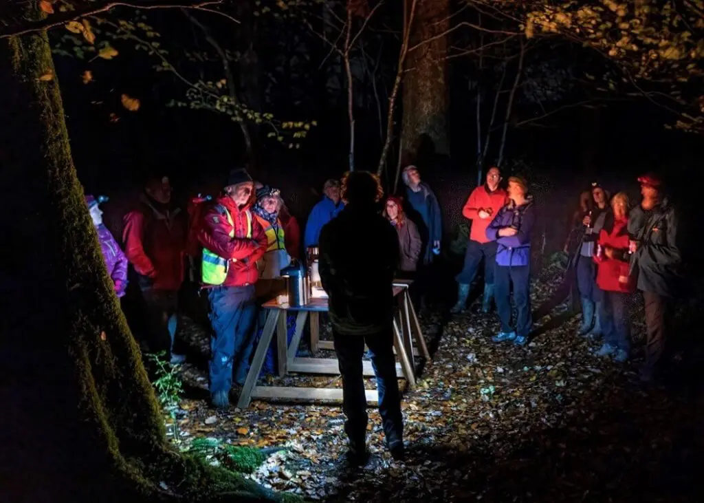 People gathered in a dark wood