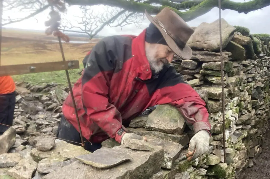 Volunteer at work dry stone walling at Mazonwath