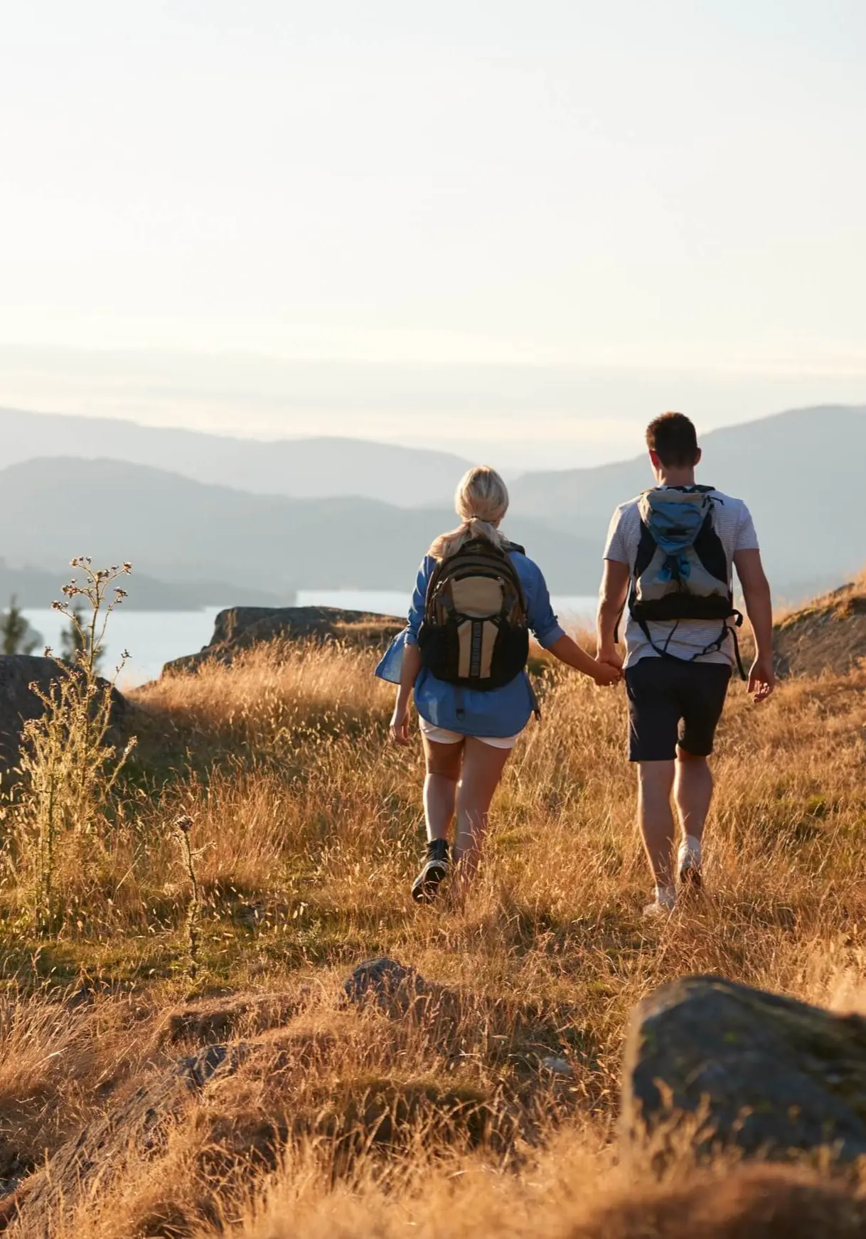 A couple walking near a lake in the Lake District