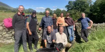 Group of volunteers and dog at Dam Mire wood work party
