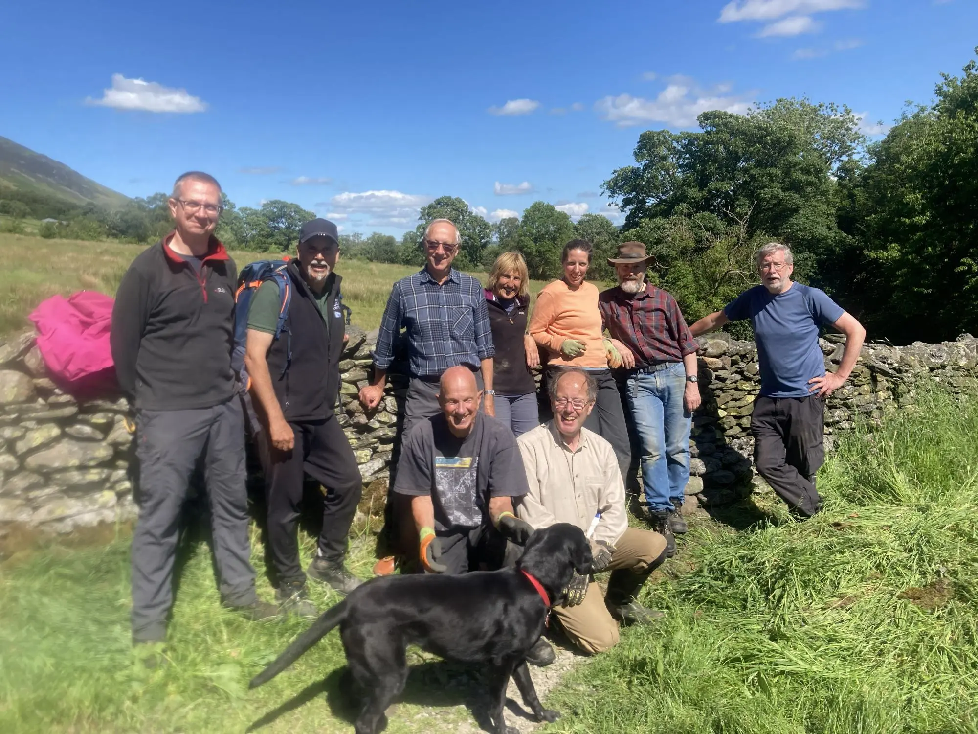 Group of volunteers and dog at Dam Mire wood work party