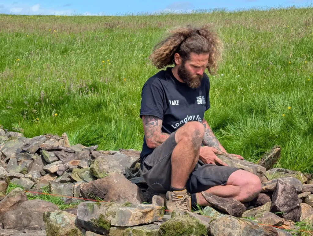 A man building a dry stone wall