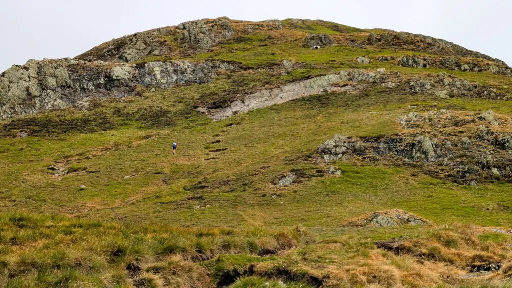 A person runs up a fell and ignores the path