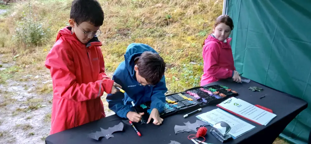 Children making paper bats craft activity