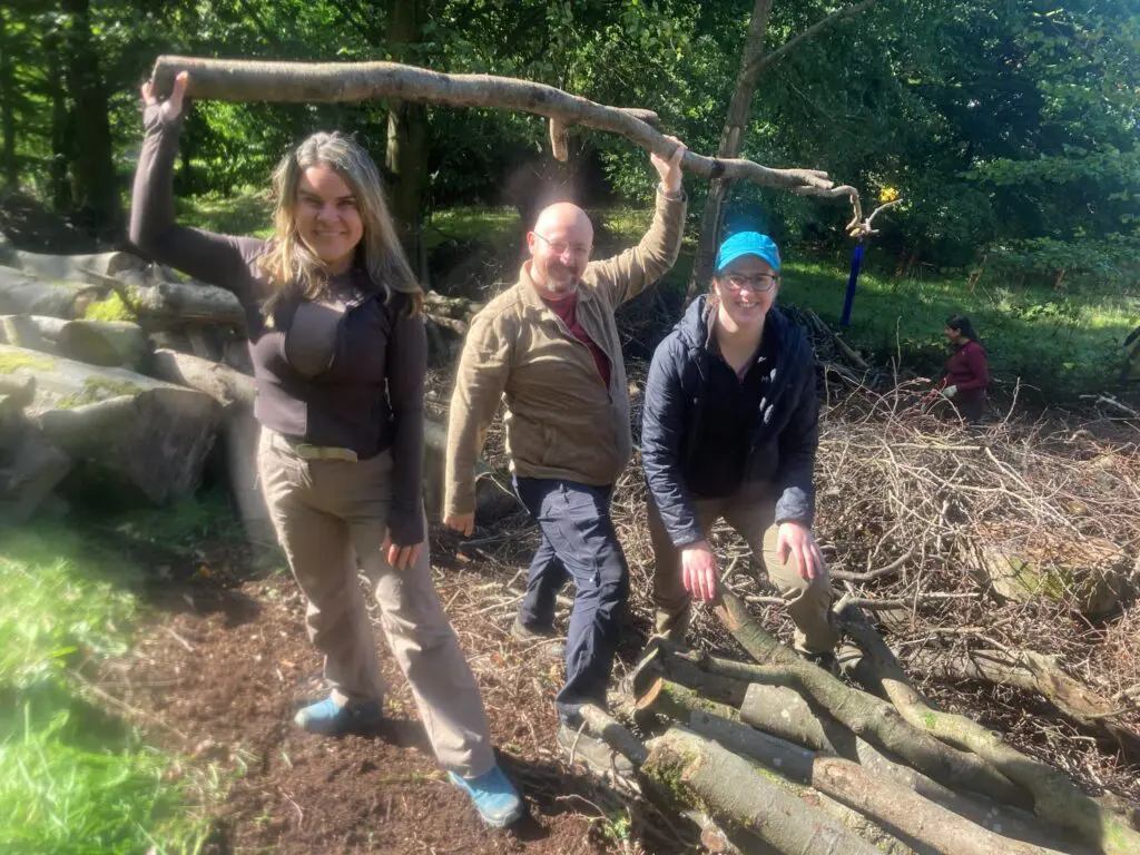 Three volunteers at a woodland workparty