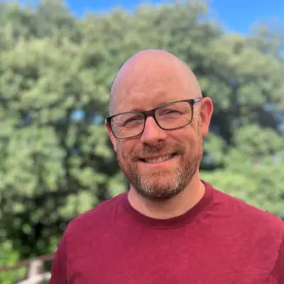Photo of a smiling man in glasses
