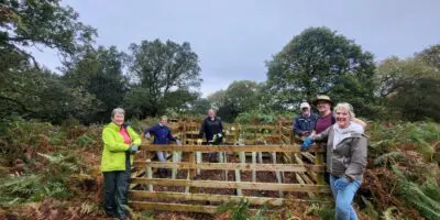 Group of volunteer next to tree enclosure