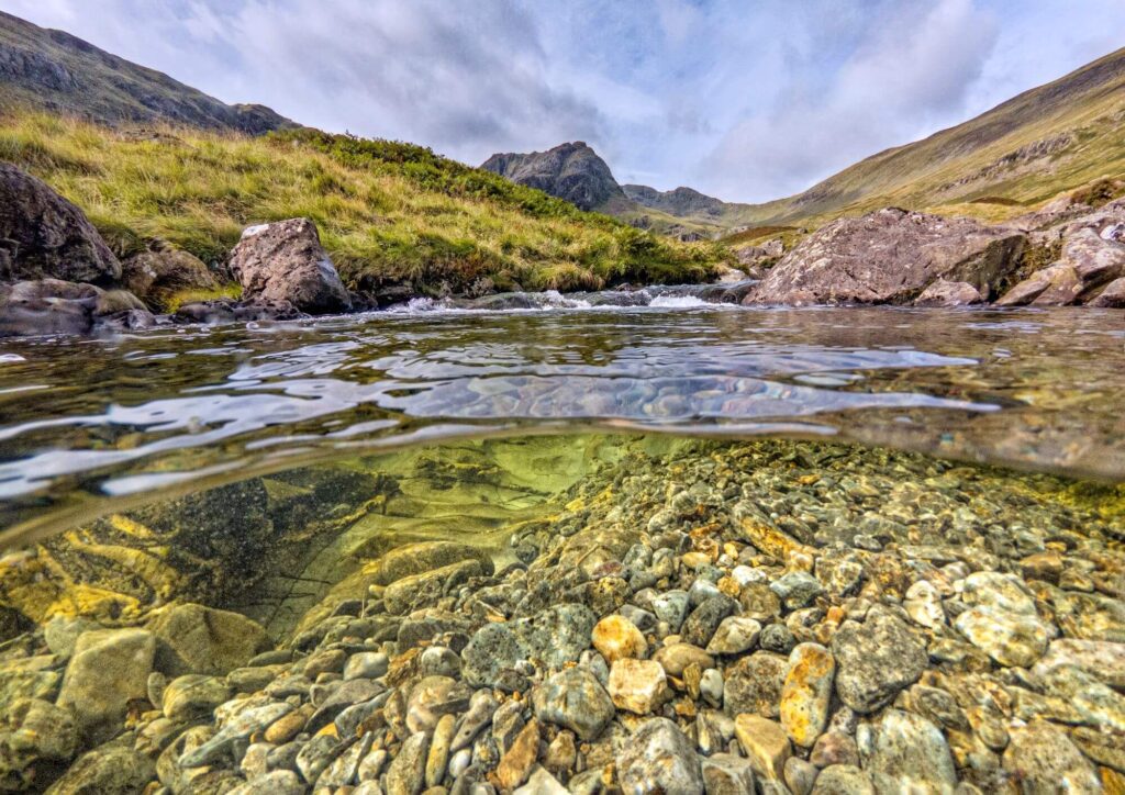 A clear pool and green hills