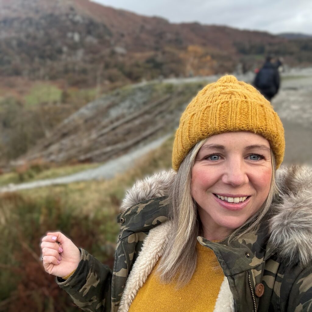 A woman in a yellow hat smiling
