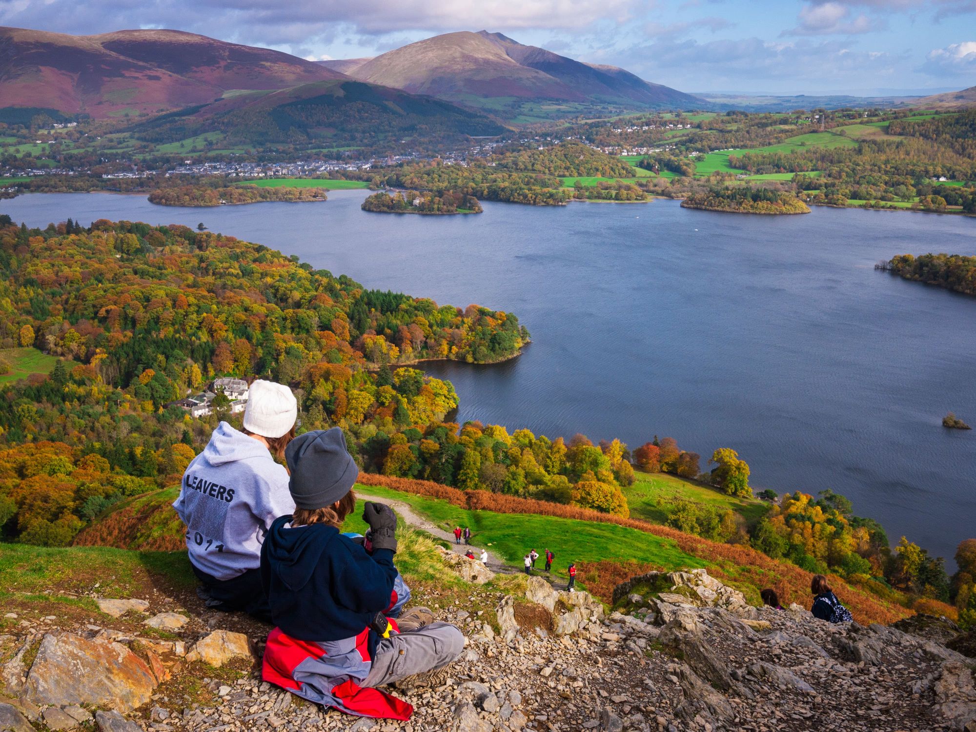 People looking across Derwentwater in the Lake District.