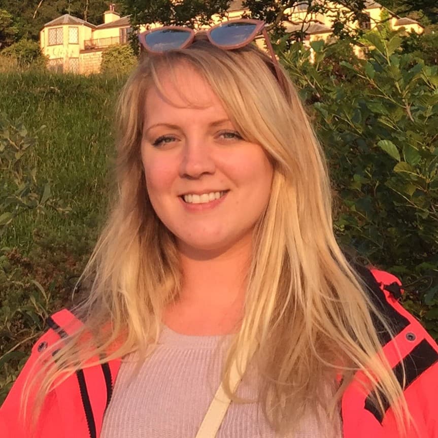 A woman smiling in sunlight