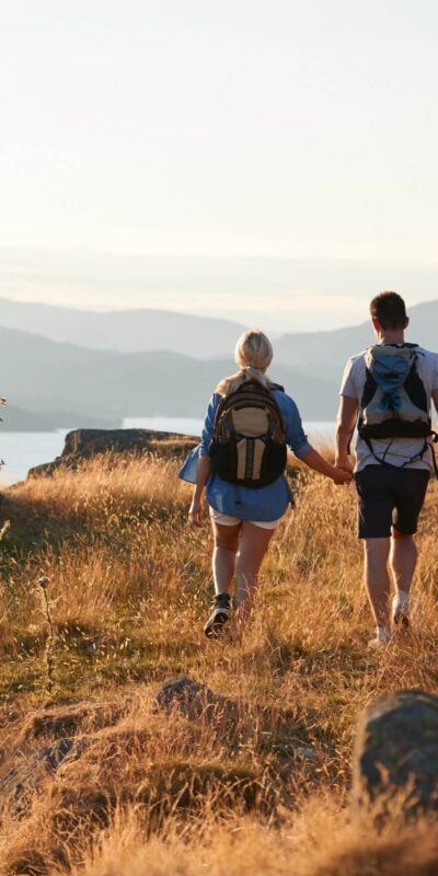 A couple walking near a lake in the Lake District